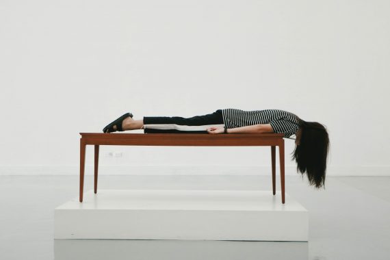 Person lying face down on a desk