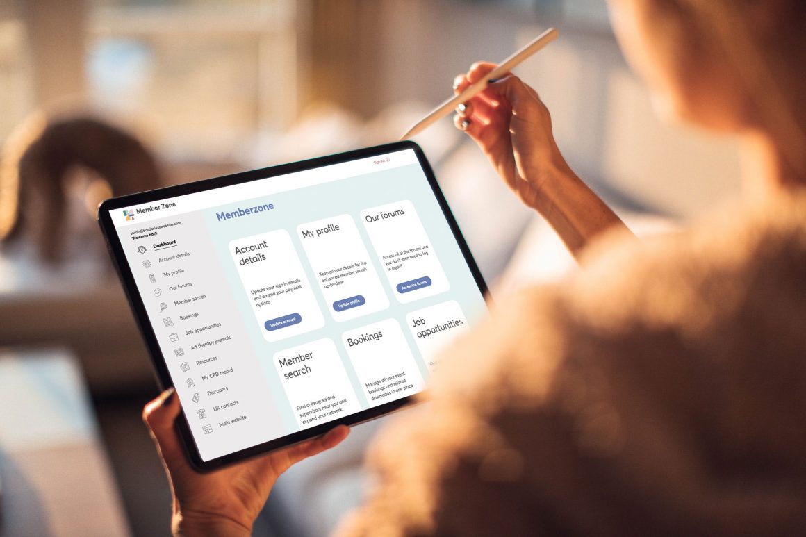a woman using a tablet with an apple pen. A memberzone is displayed on the screen