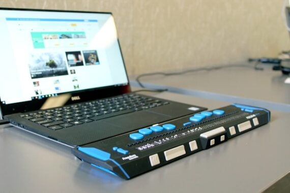 A laptop with a special key pad with blue buttons to enable access to the use of the laptop for the impaired.