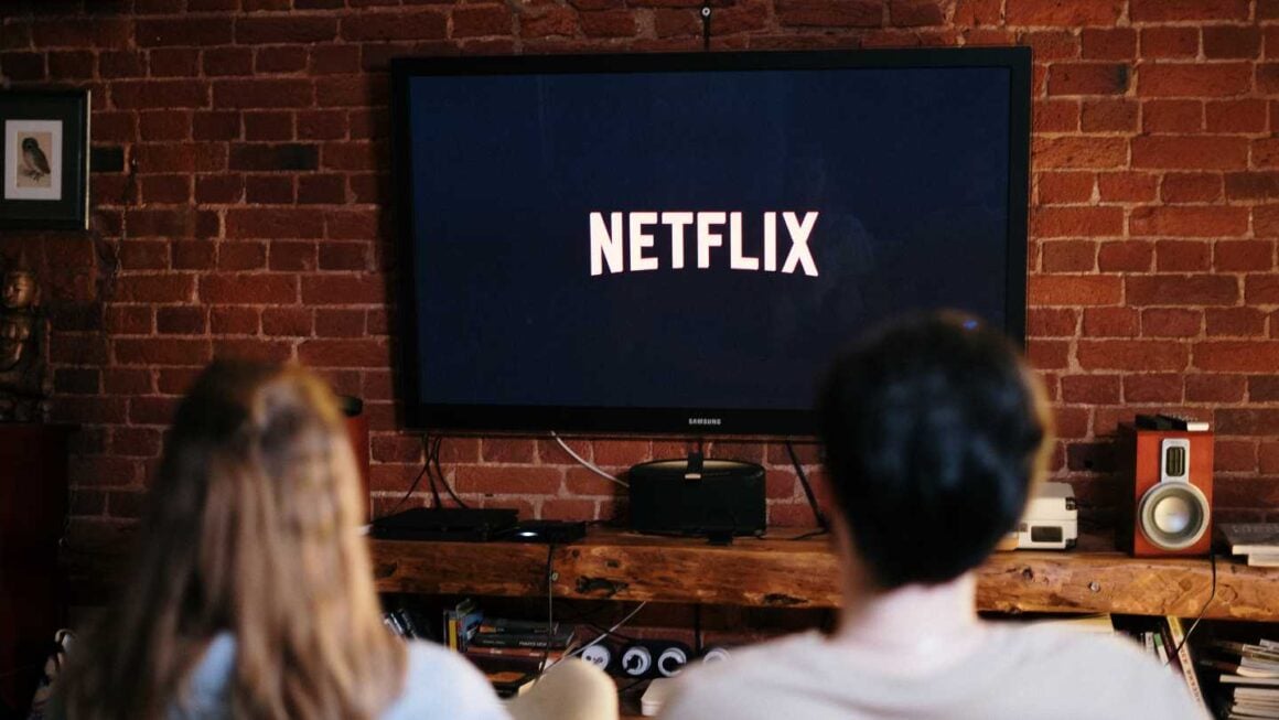 a man and a woman watching tv 